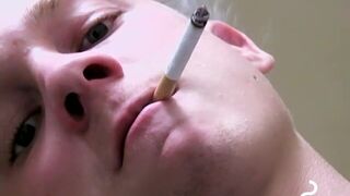 Twink savors the pleasure of smoking & stroking dick